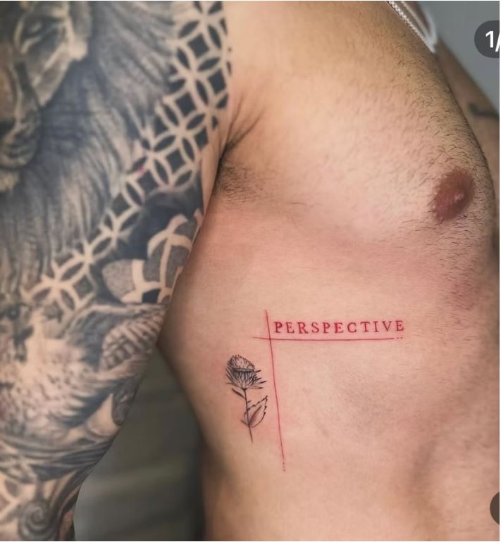 "PERSPECTIVE" red ink tattoo with thistle