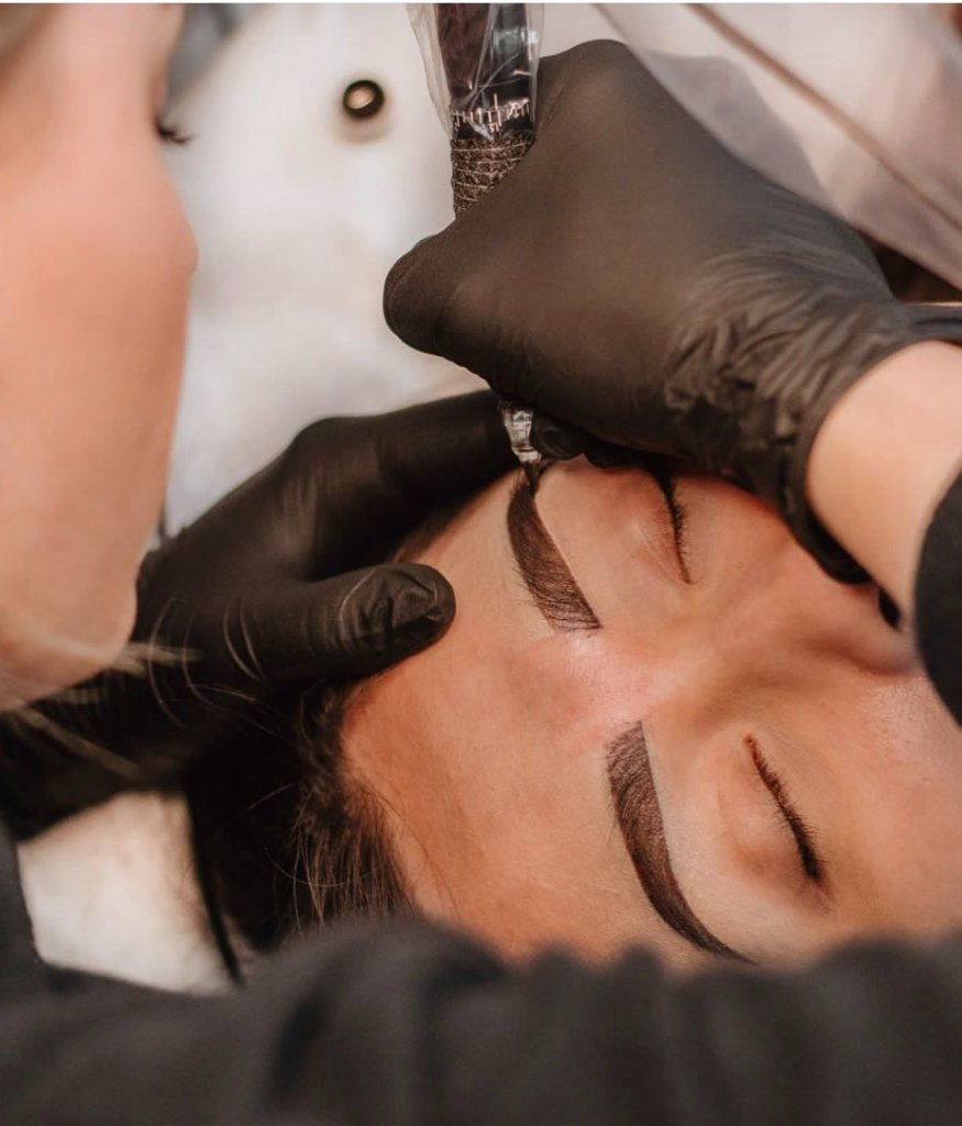Eyebrow tattoo procedure in progress