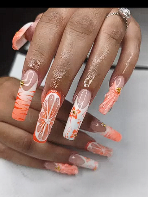 Square nails with citrus orange slice designs and floral patterns