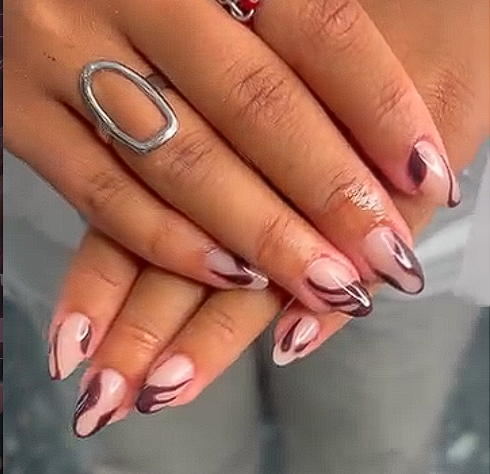 Pink French nails with dark brown abstract swirl designs