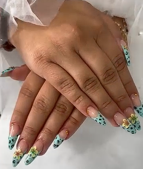 Almond nails with light blue leopard print tips and gold floral accents