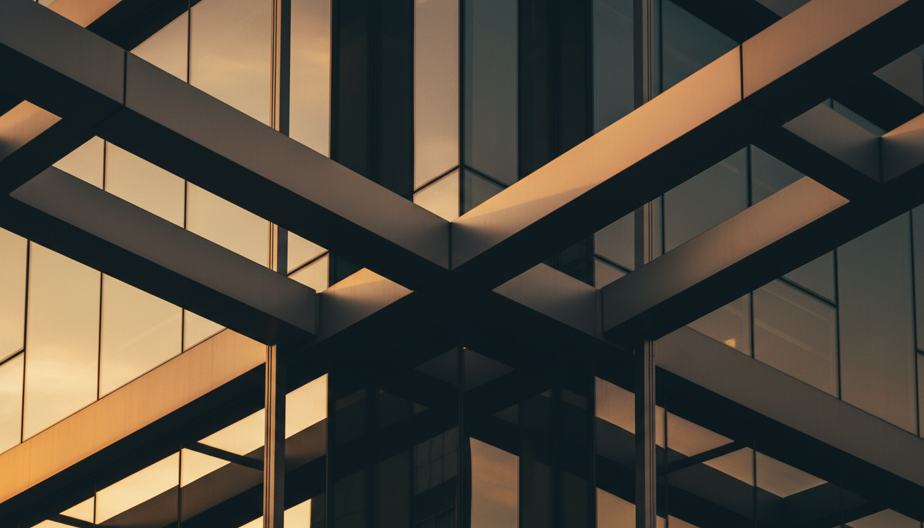 Modern architectural glass and steel building with warm golden light