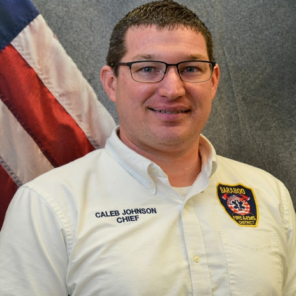 Portrait of Fire/EMS Chief Caleb Johnson in district uniform