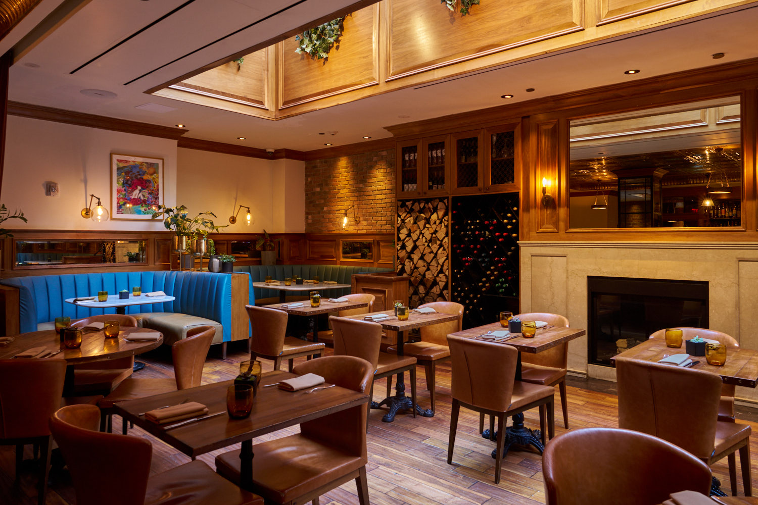 Intimate dining area with blue banquette and fireplace at Society Cafe
