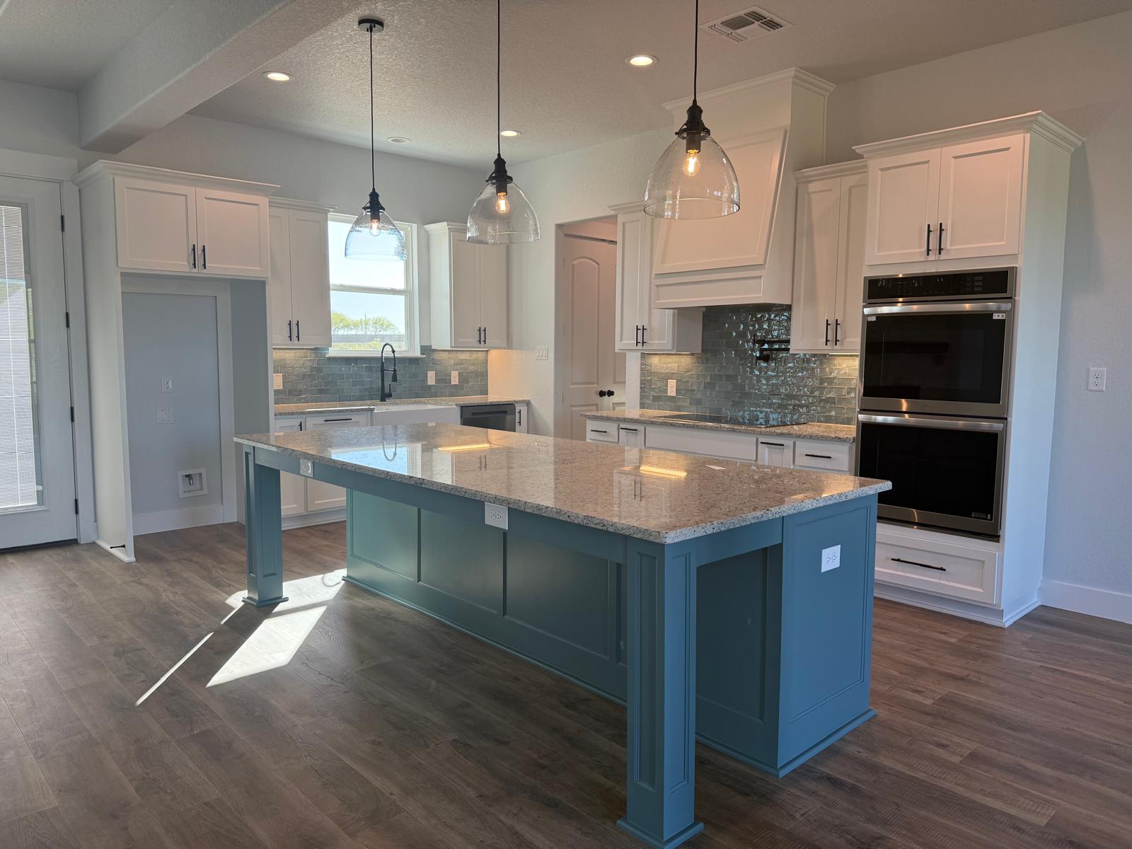 White custom kitchen cabinets with blue island by CJ Cabinets