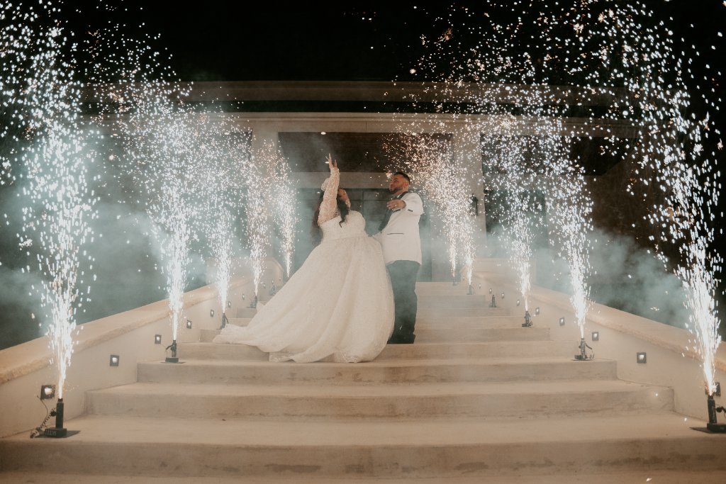 Couple on stairs with cold spark fireworks at night