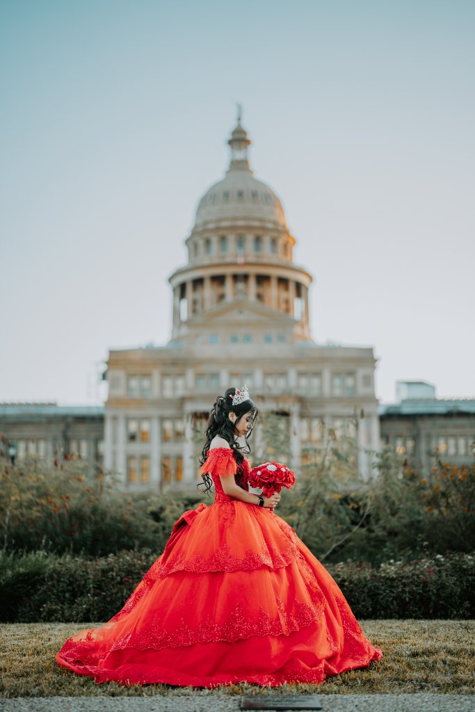 Quinceañera in red dress at the Texas State Capitol