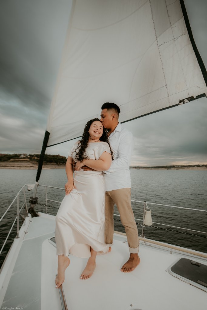 Couple embracing on sailboat deck