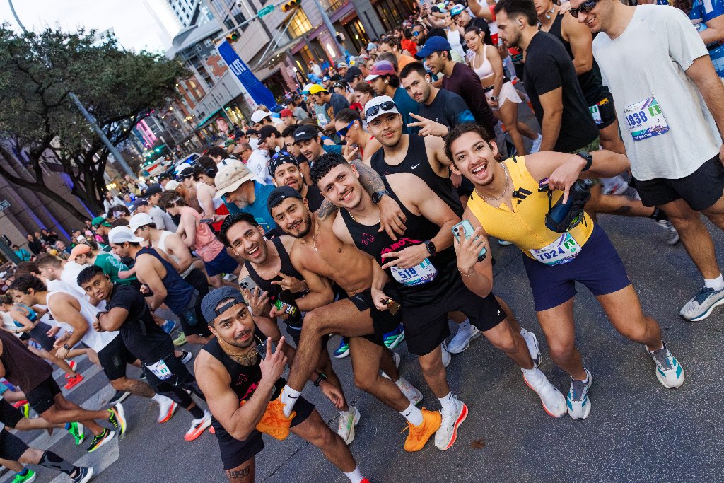 Group of friends posing together on race course