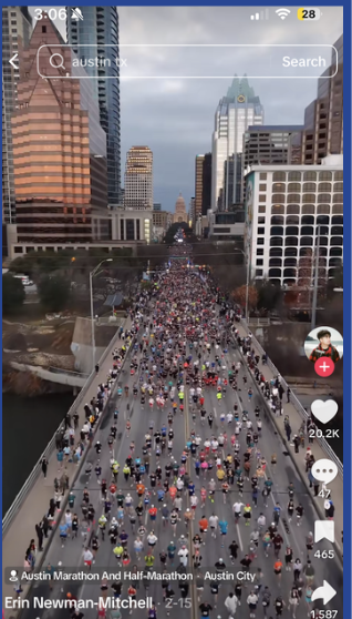 Massive crowd of runners on Congress Avenue with Capitol