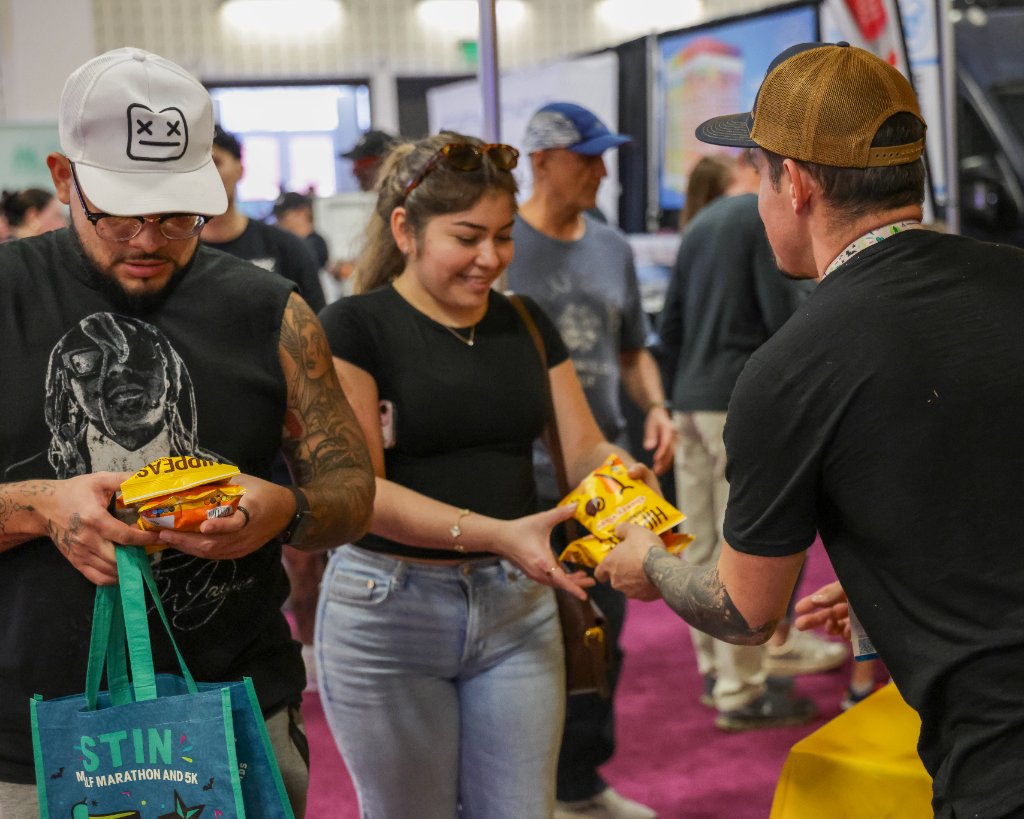 Vendor handing out snacks on expo floor