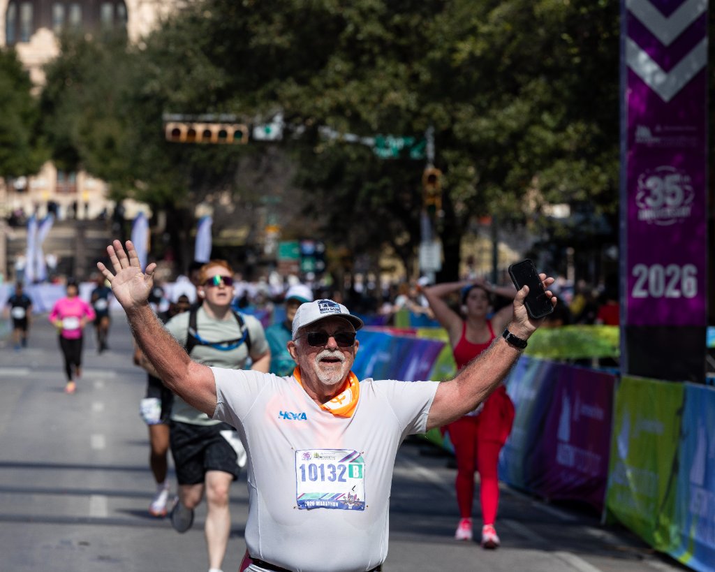 Crowd of runners with Austin skyline