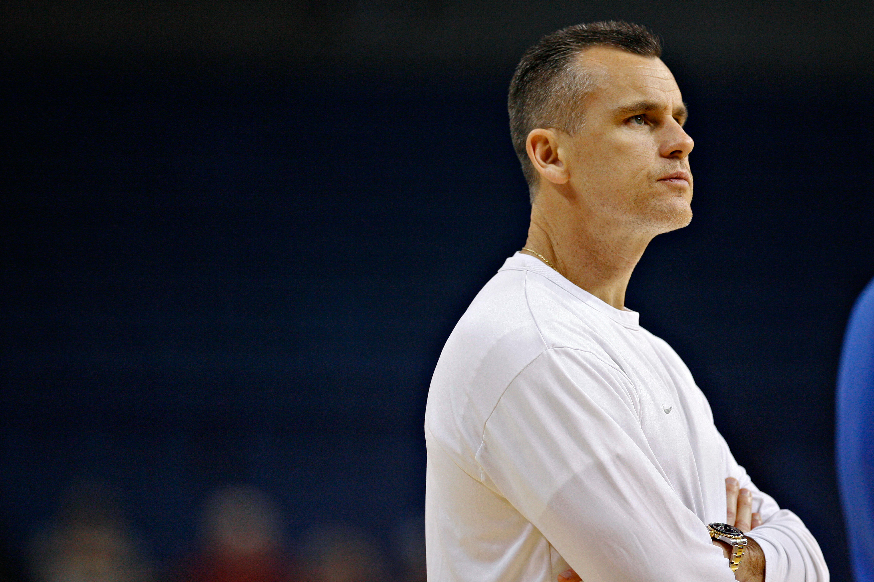 Basketball coach in a white shirt with arms crossed