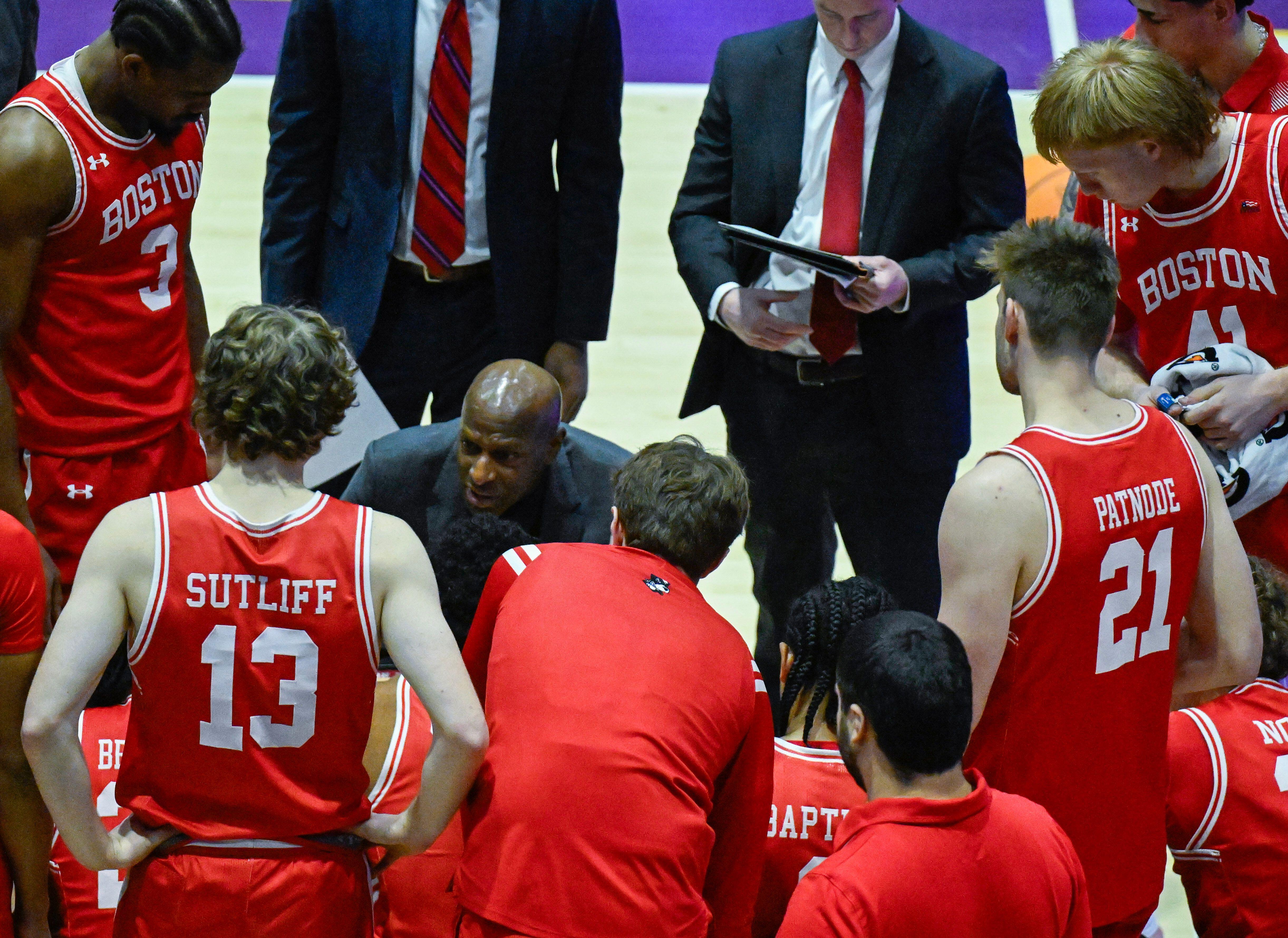 Basketball coach talking to players in a huddle