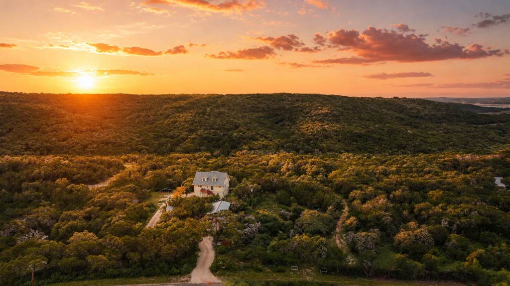 Aerial view of 17.21-acre Texas Hill Country ranch at golden hour