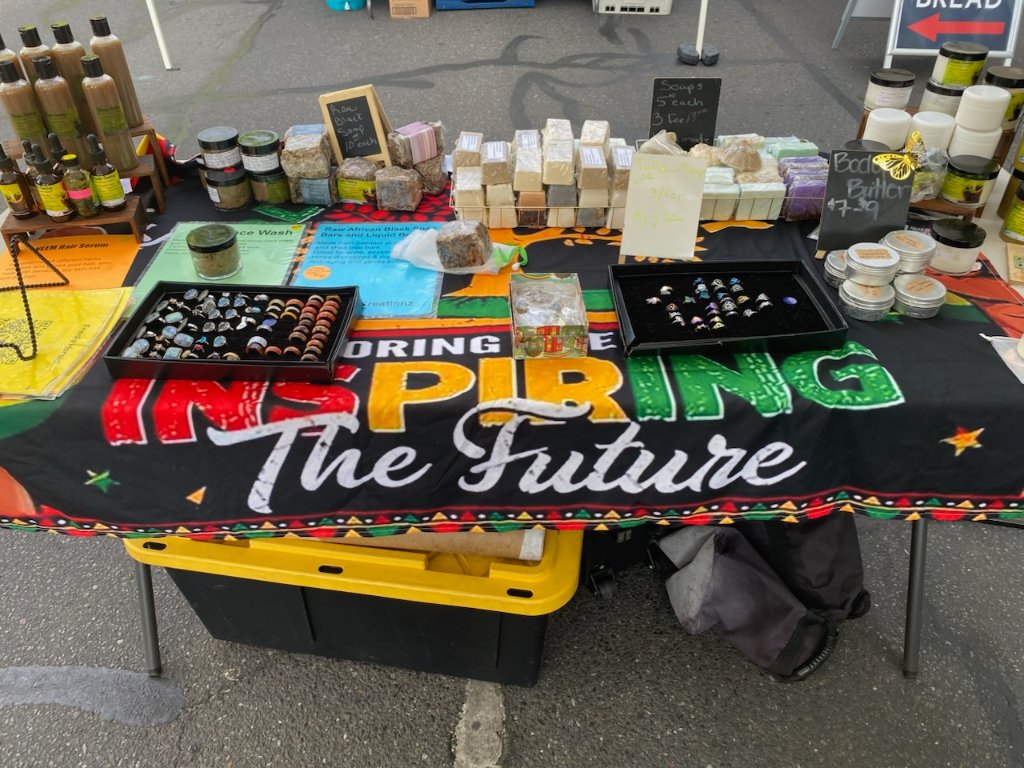 Fredia's market booth with handcrafted organic products