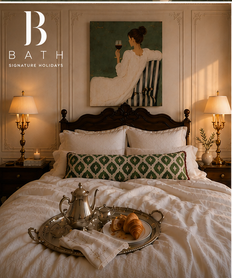 Luxurious bedroom with breakfast tray, ornate gold lamps and framed art
