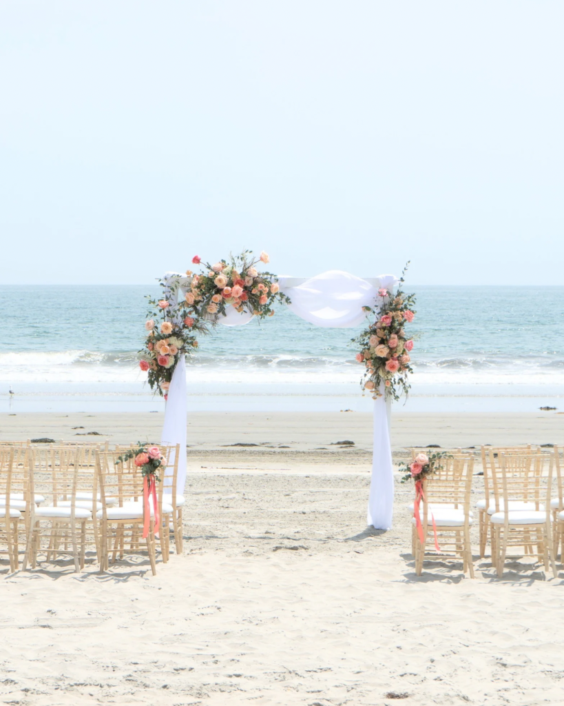 Florida beach wedding ceremony with floral arch
