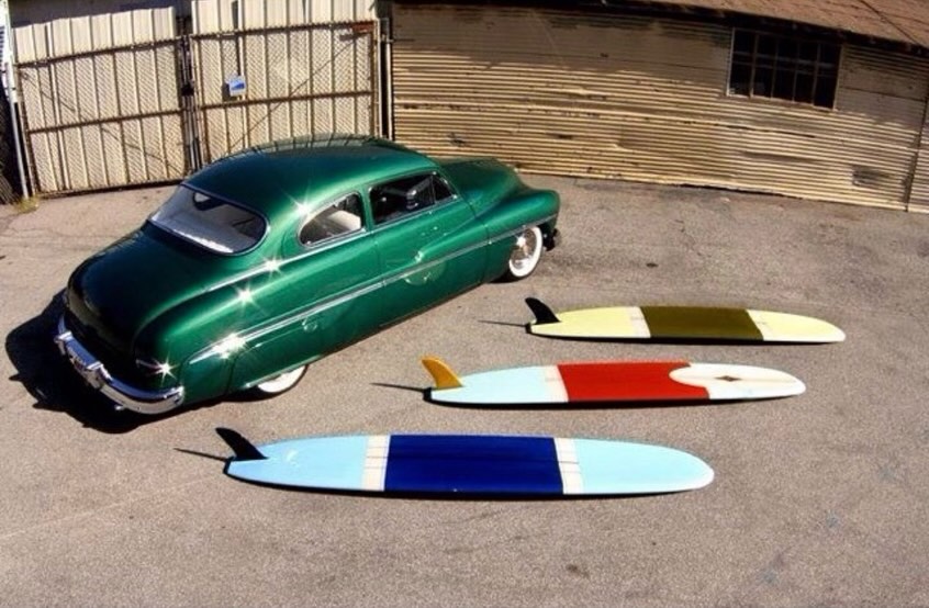 Longboard jaune — fin rouge, vue parking