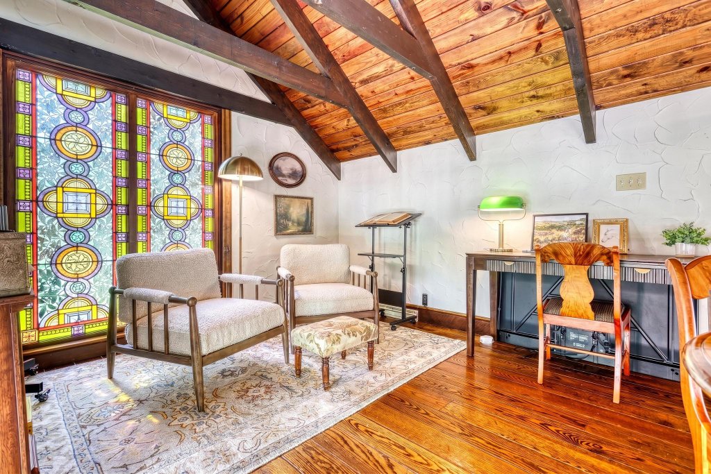 Cozy loft sitting room with stained-glass window and writing desk