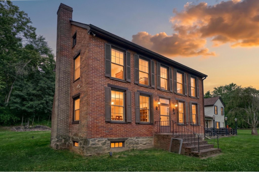 Historic red-brick facade of The Baladerry Inn at sunset