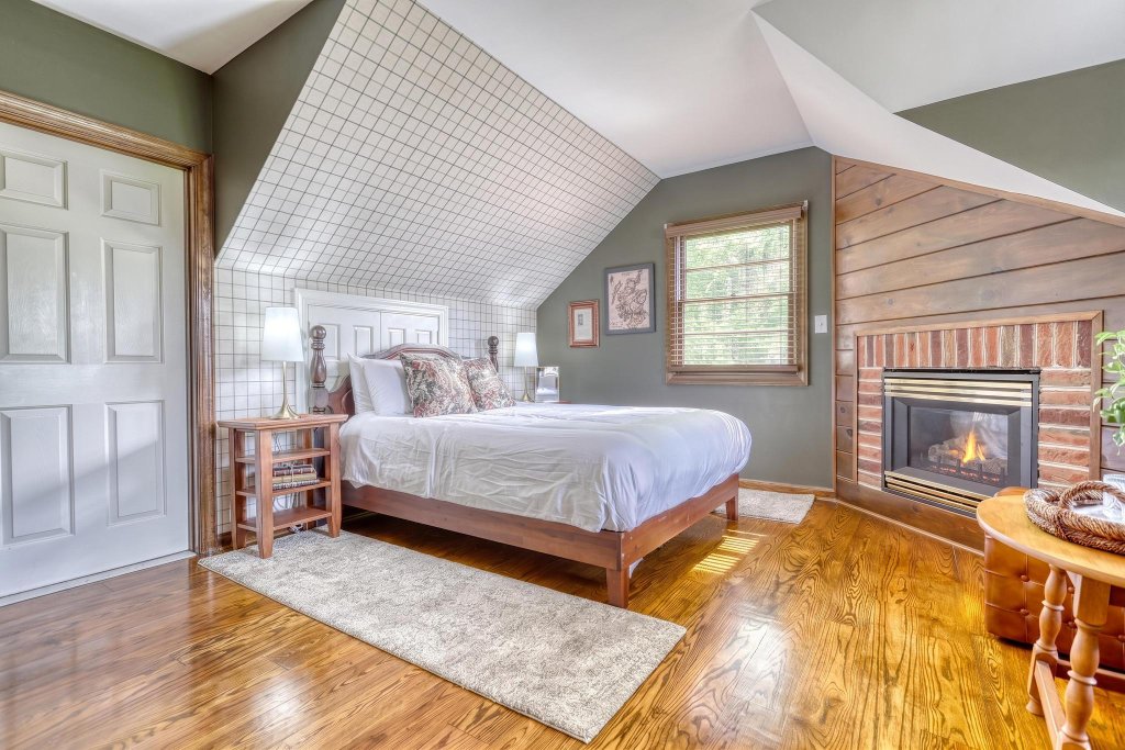 Attic-style guest suite with fireplace and garden views