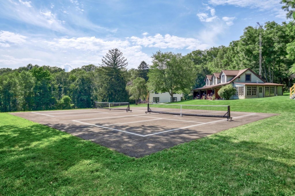 Outdoor pickleball court set on the lawn under a clear sky