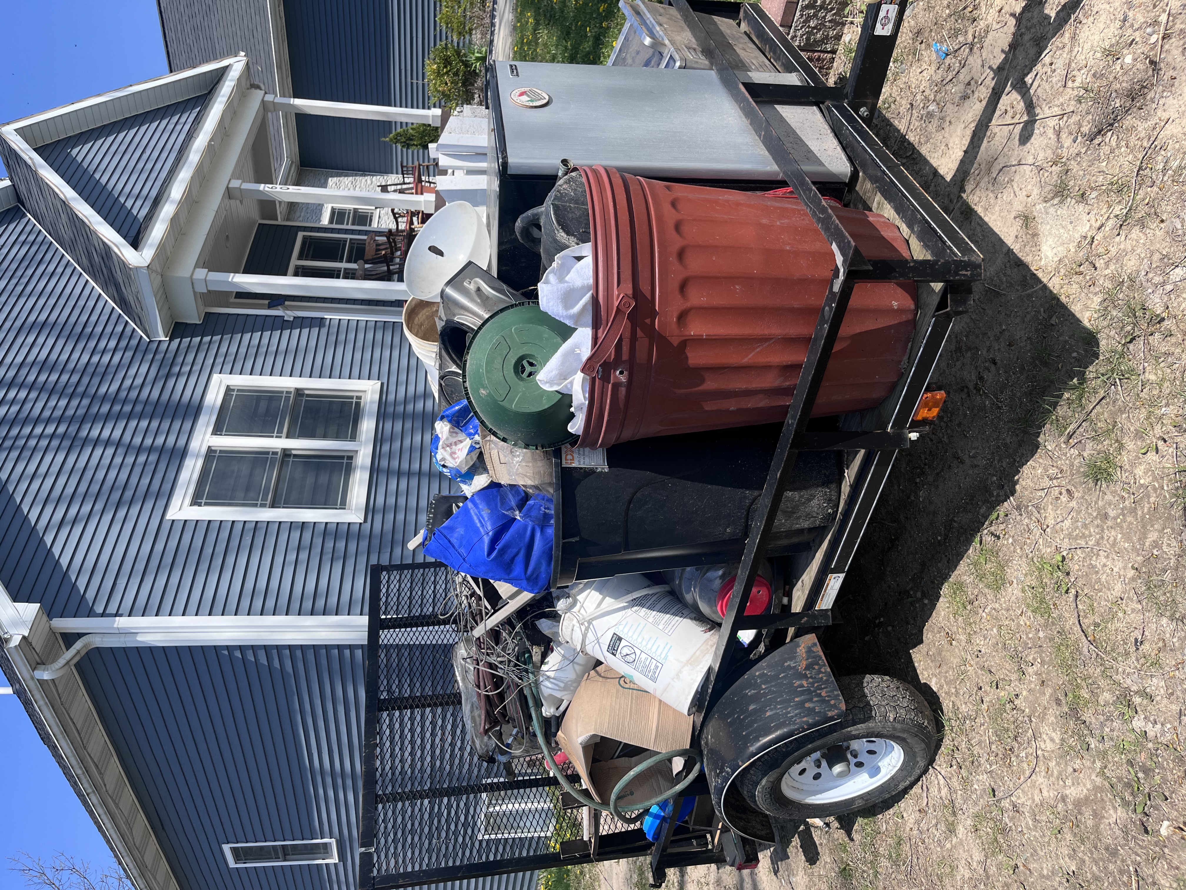 Uniformed SwiftLine Junk Removal crew with their removal truck ready to haul junk for a homeowner in Hastings, Michigan