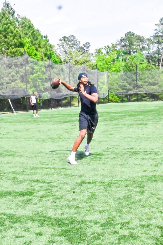 Quarterback in mid-dropback during individual session
