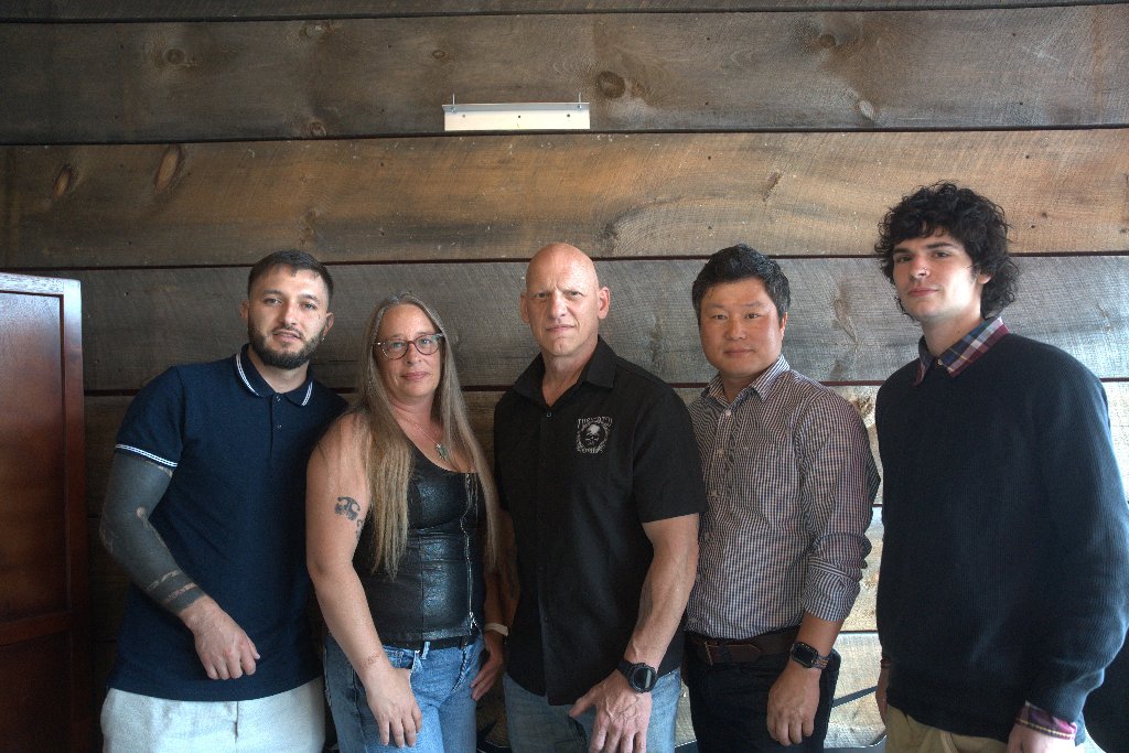 The Tormented Souls crew photographed against a reclaimed wood wall