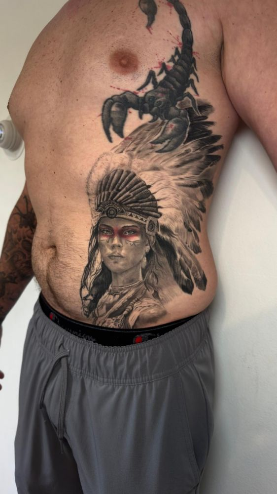 Native American headdress portrait with scorpion — black & grey realism by Santiago