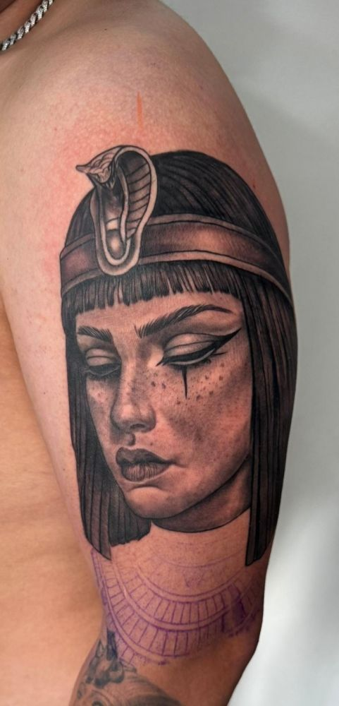 Woman portrait with cobra headdress — black & grey realism tattoo by Santiago
