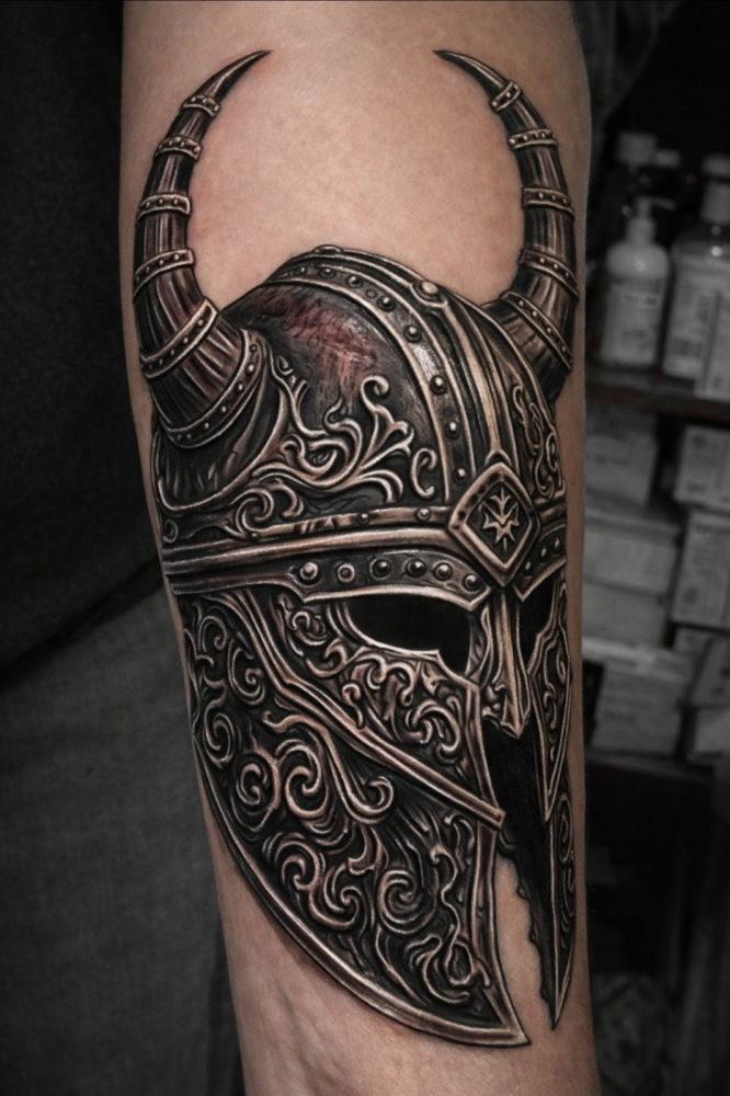 Ornate Viking helmet tattoo by Steve Gagliano