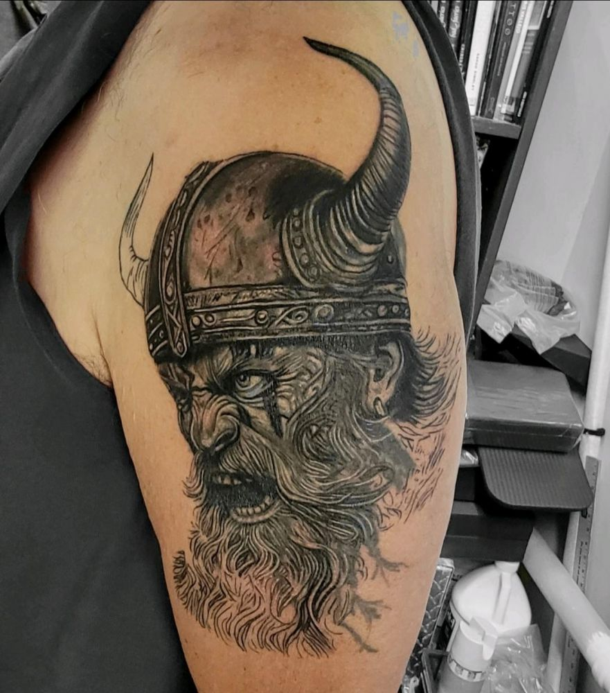 Viking warrior profile with horned helmet tattoo by Steve Gagliano