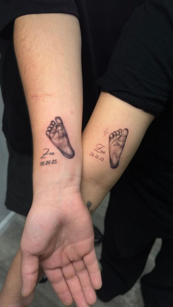 Zoe memorial infant footprints — black & grey realism tattoo by Santiago