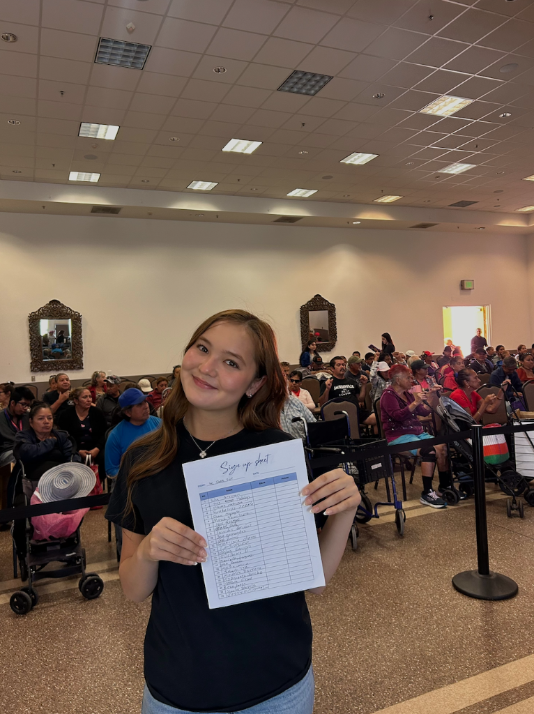 Volunteer holding sign-up sheet at June 22 health fair