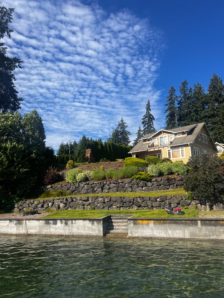 Waterfront property with terraced lawn and stone retaining walls