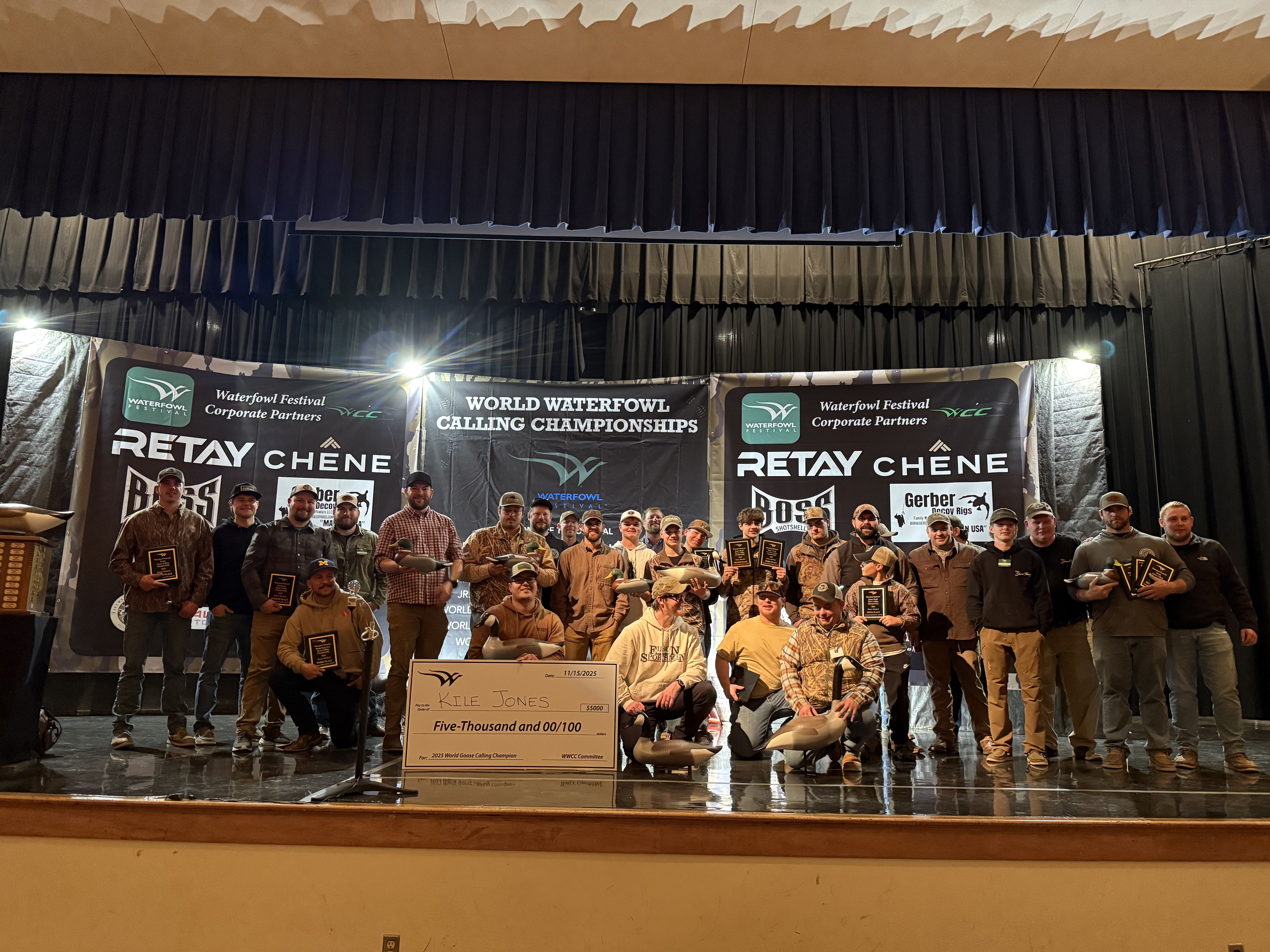 2025 World Goose Calling Champion Kile Jones and competitors on stage at the World Waterfowl Calling Championships