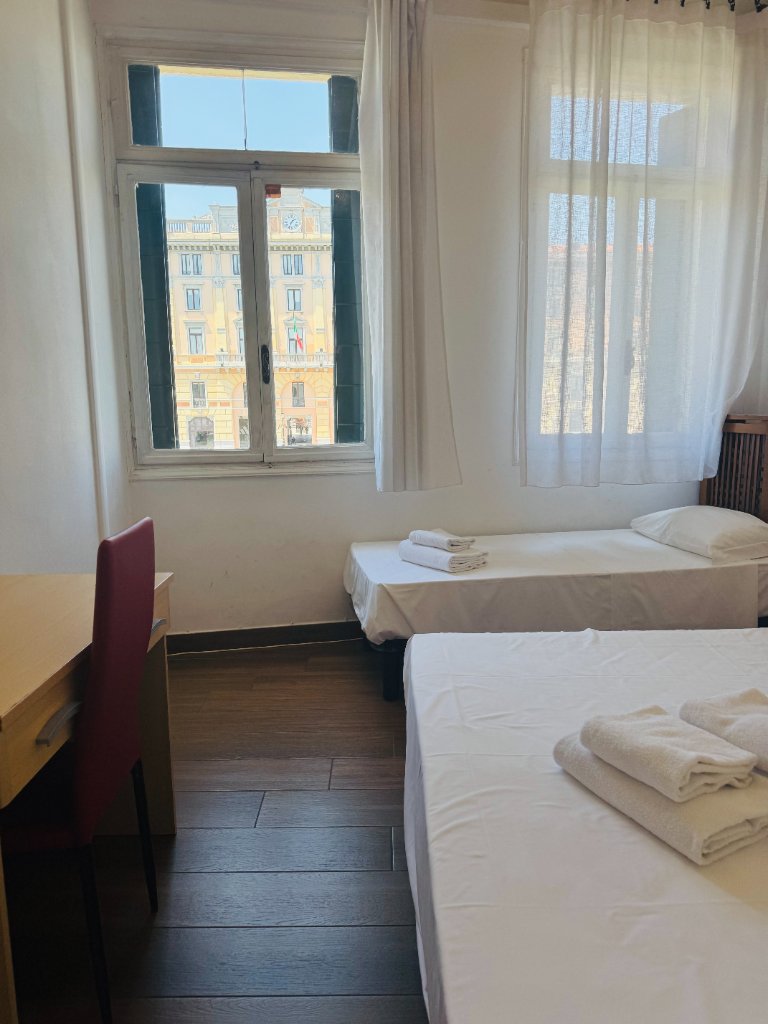 Hotel room with canal view of a yellow historic building