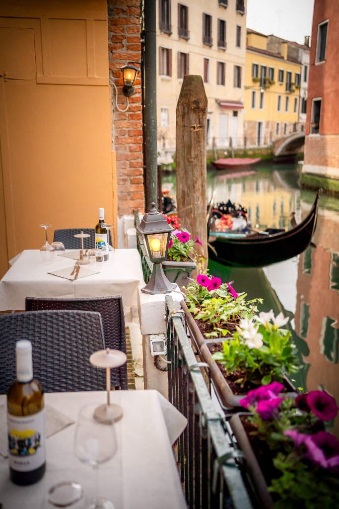 Canal-side dining terrace at Trattoria Alla Terrazza