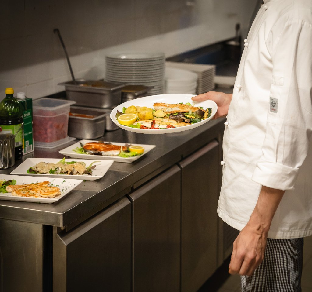 Chef preparing plates in the kitchen
