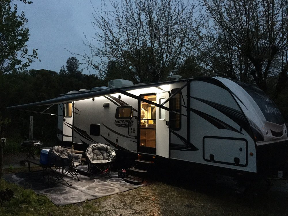 RV set up for a cozy long-term stay at dusk