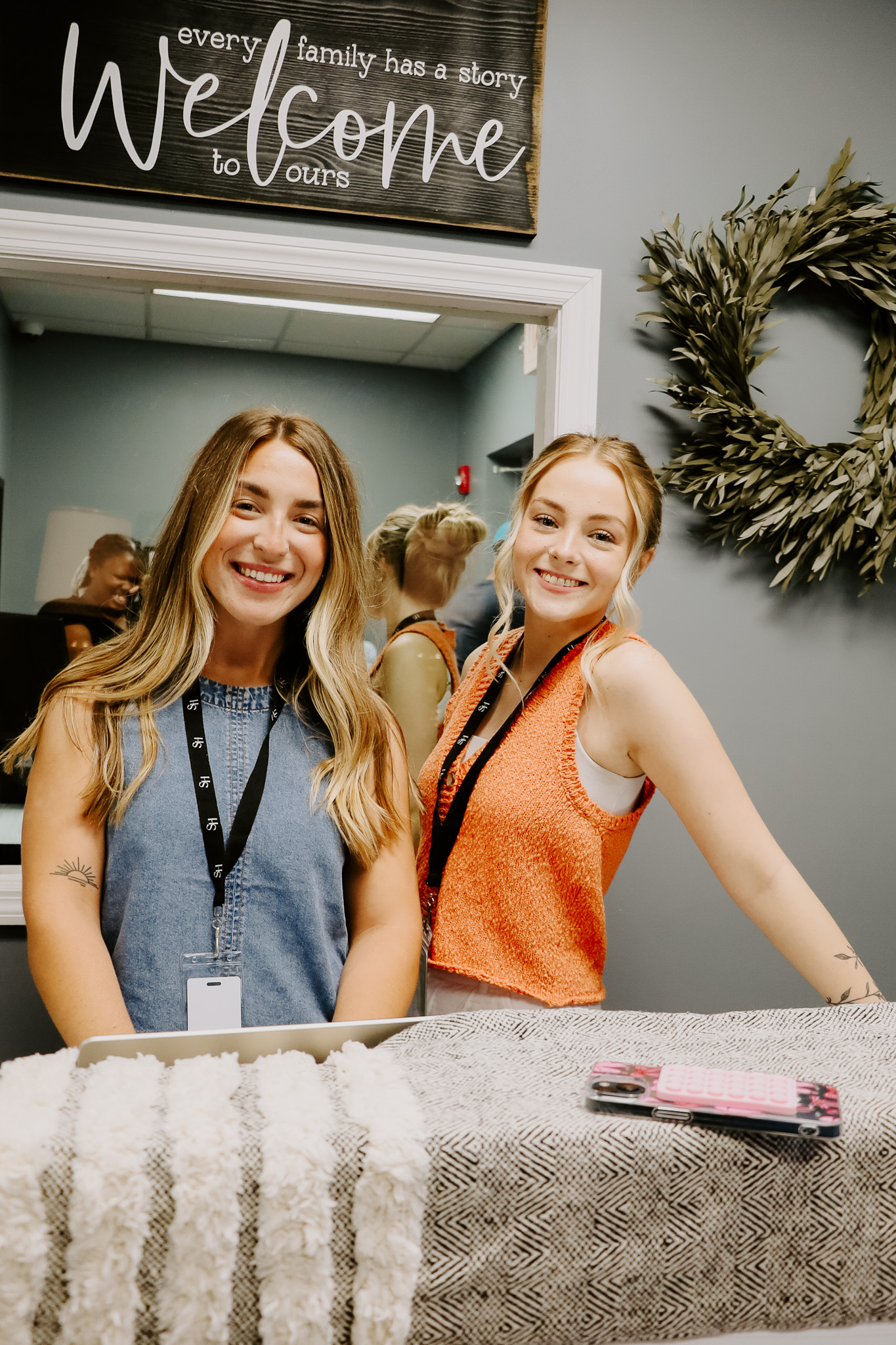 Two women smiling behind the counter