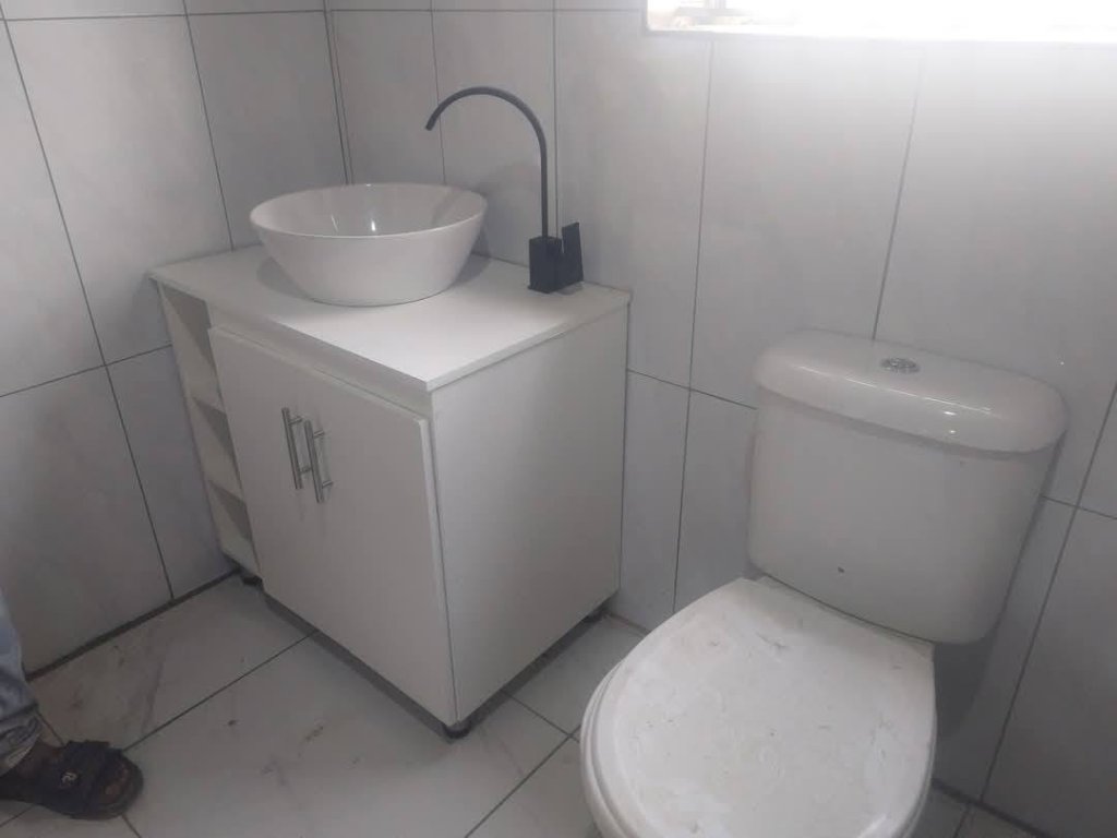 Modern bathroom installation with vanity and toilet