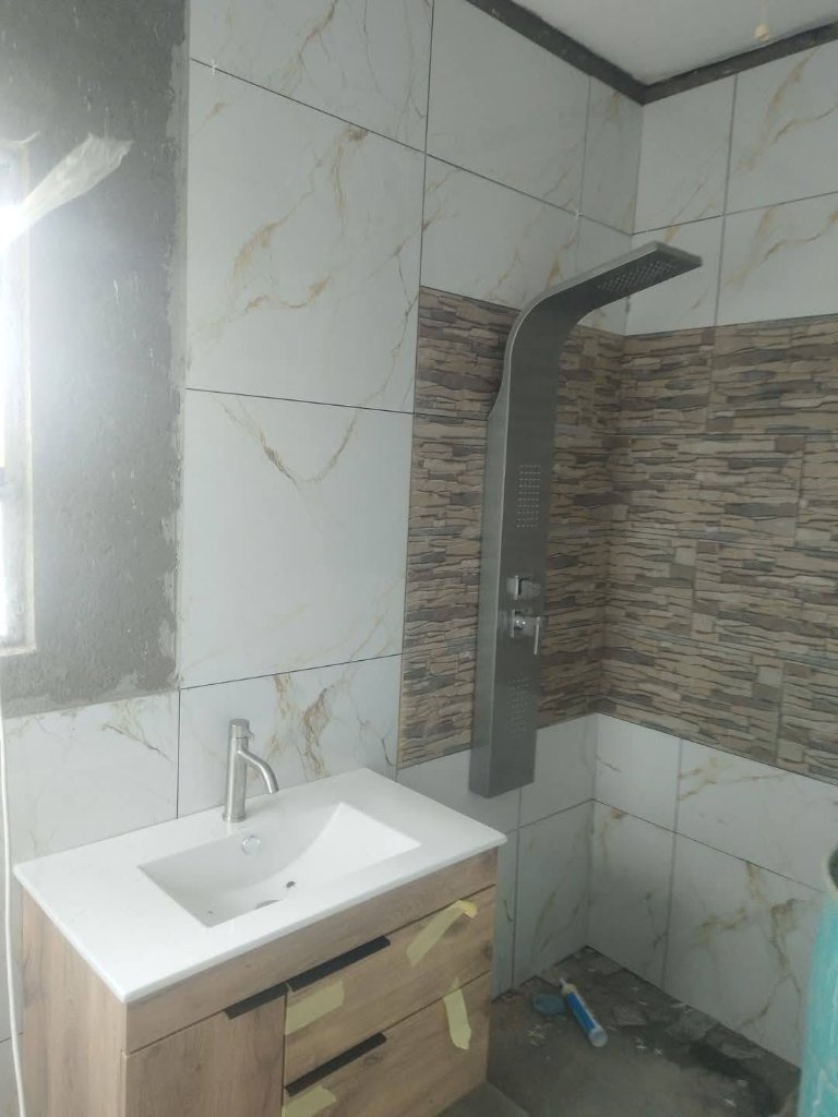 Bathroom renovation with oak vanity and shower system
