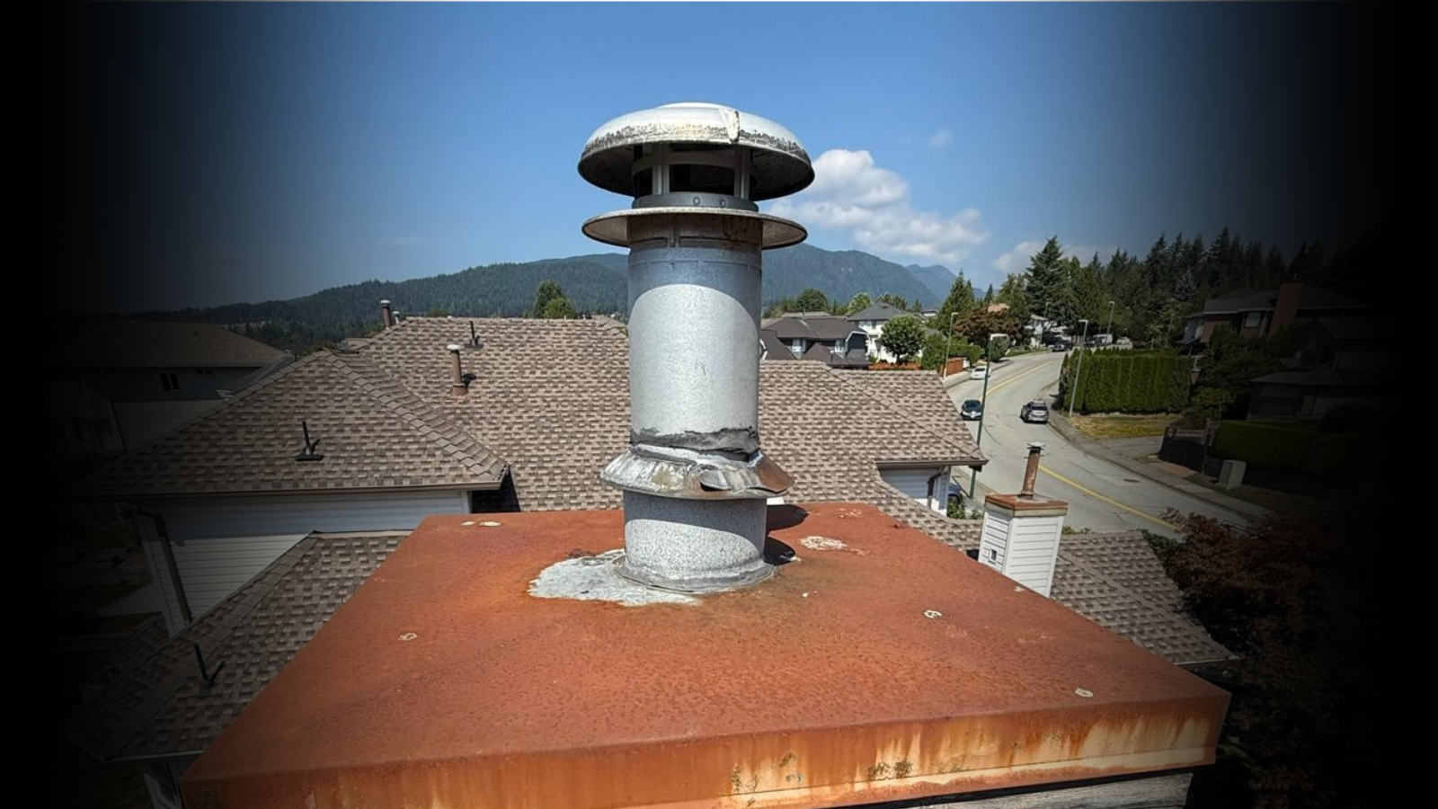 Rusted chimney flashing and old roof before reroofing in Kerrisdale, Vancouver BC