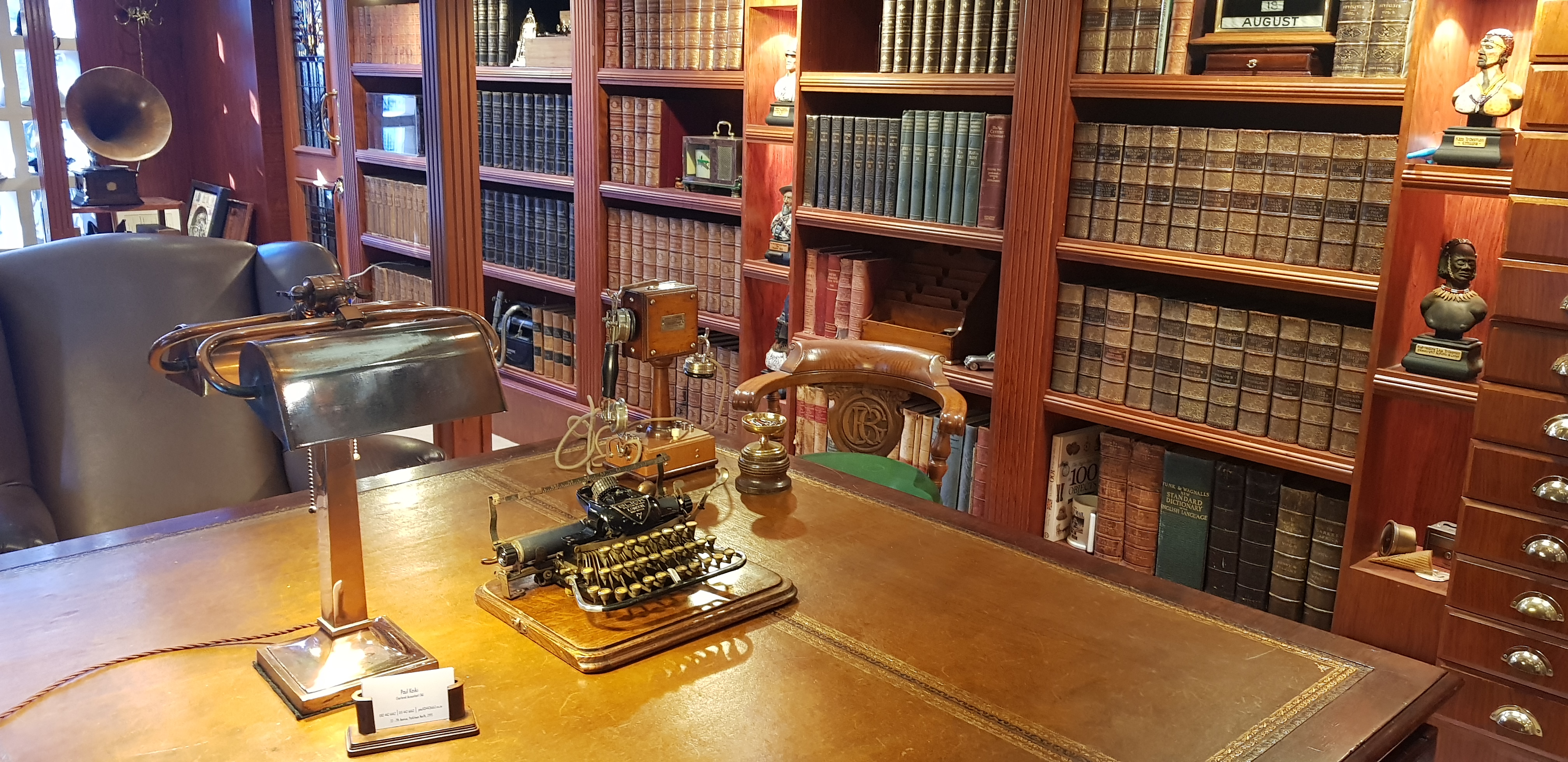 Traditional study with a leather-topped desk and floor-to-ceiling bookshelves