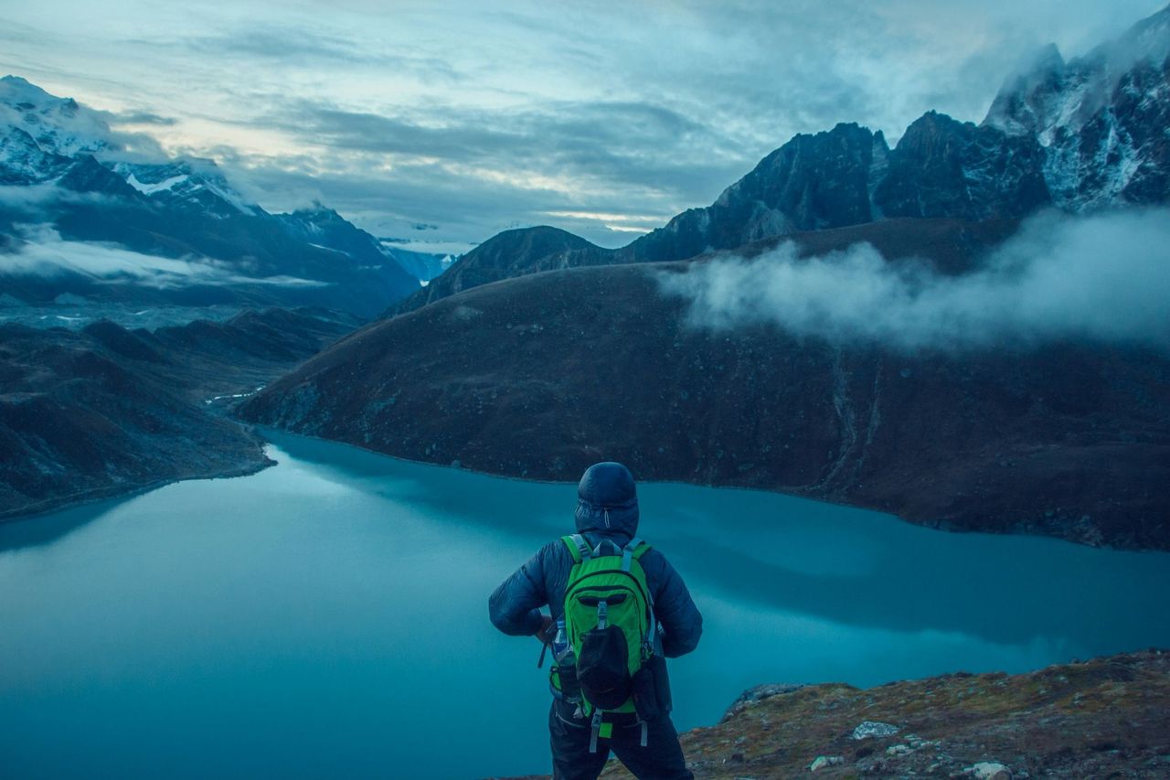 Hiker above a glacial lake