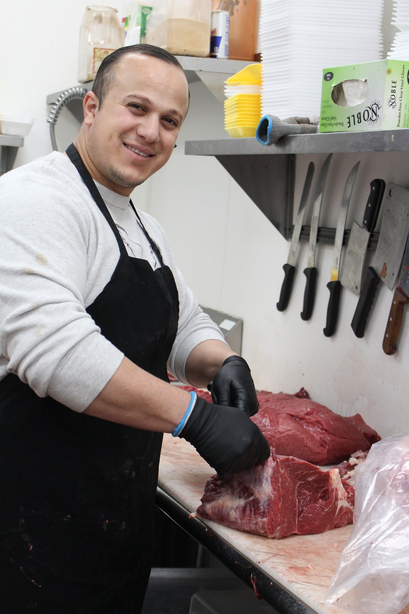 Butcher preparing fresh cuts of meat at Pangea