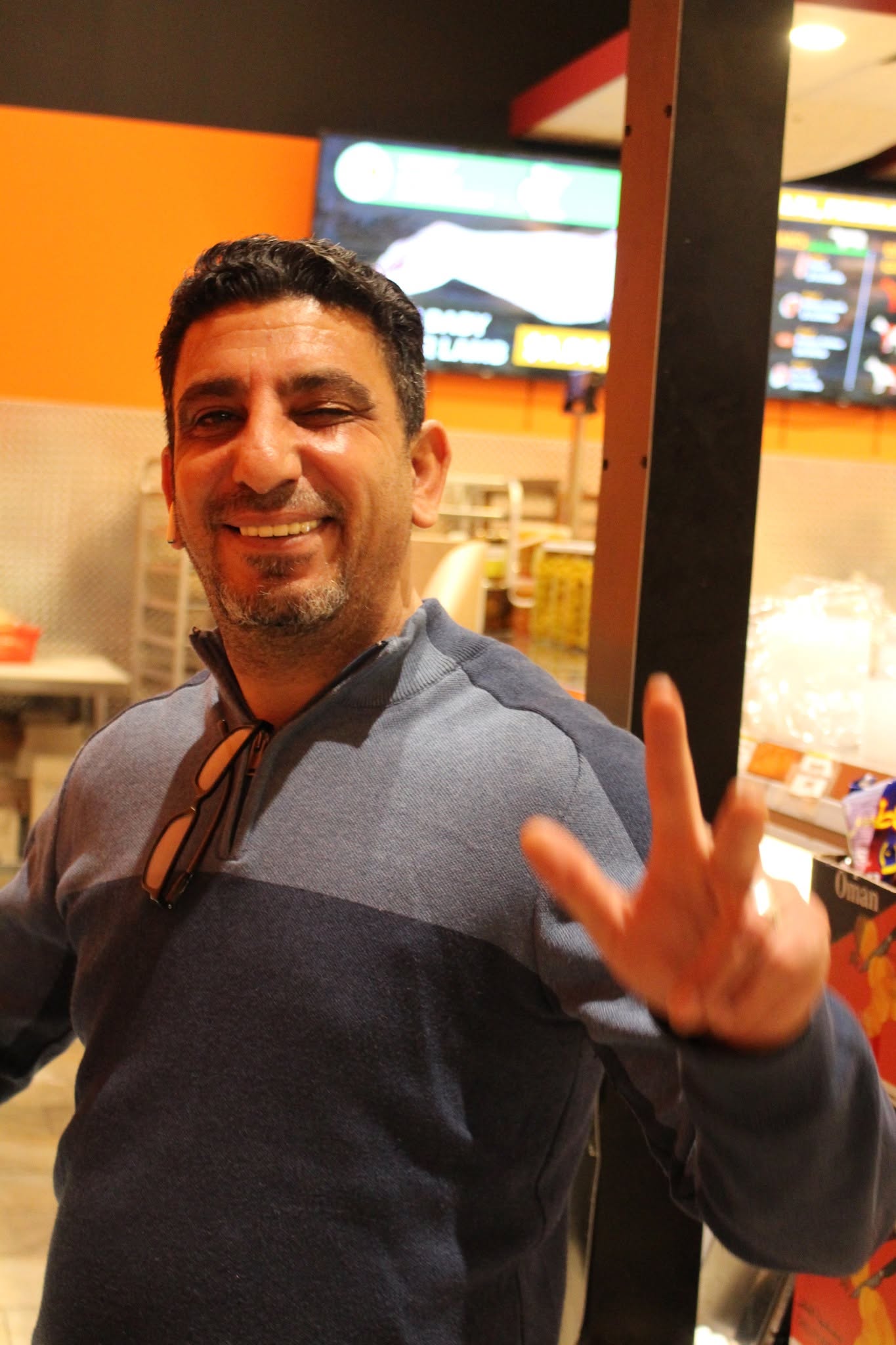 Smiling Pangea team member greeting a customer